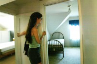Kellie Holzer, age 31, from Seattle Wash. checks out a house she would love to buy but cannot afford in the Ballard neighbord on August 7, 2005. (Photo © Karen Ducey Photography. For the series 